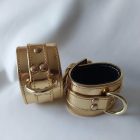 gold-colored leather bdsm wrist cuff, top view, handmade