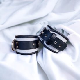 White and black leather wrist cuffs