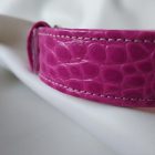 pink leather bdsm collar, crocodile-patterned, close-up, handmade